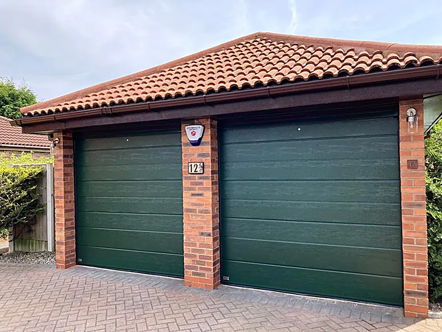 Green steel garage doors on a double garage in Gauteng