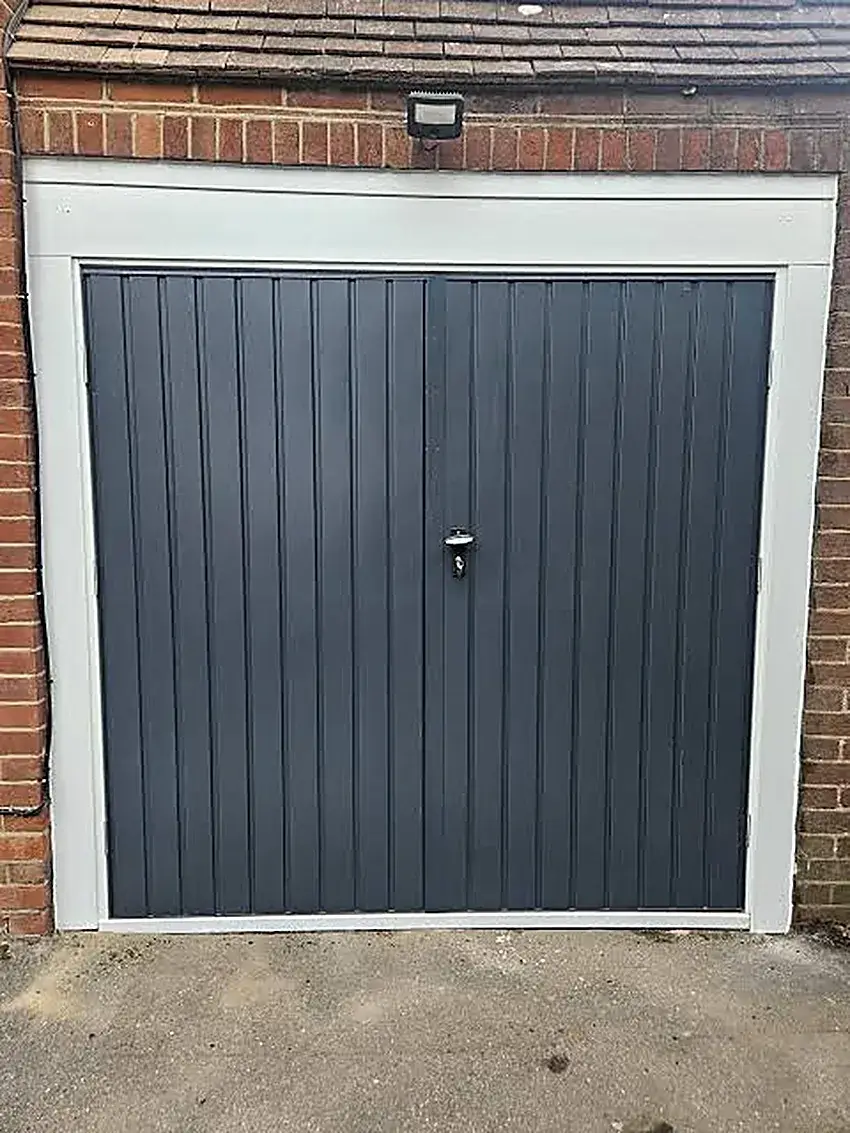 Older tip-up garage door on a home in Springs